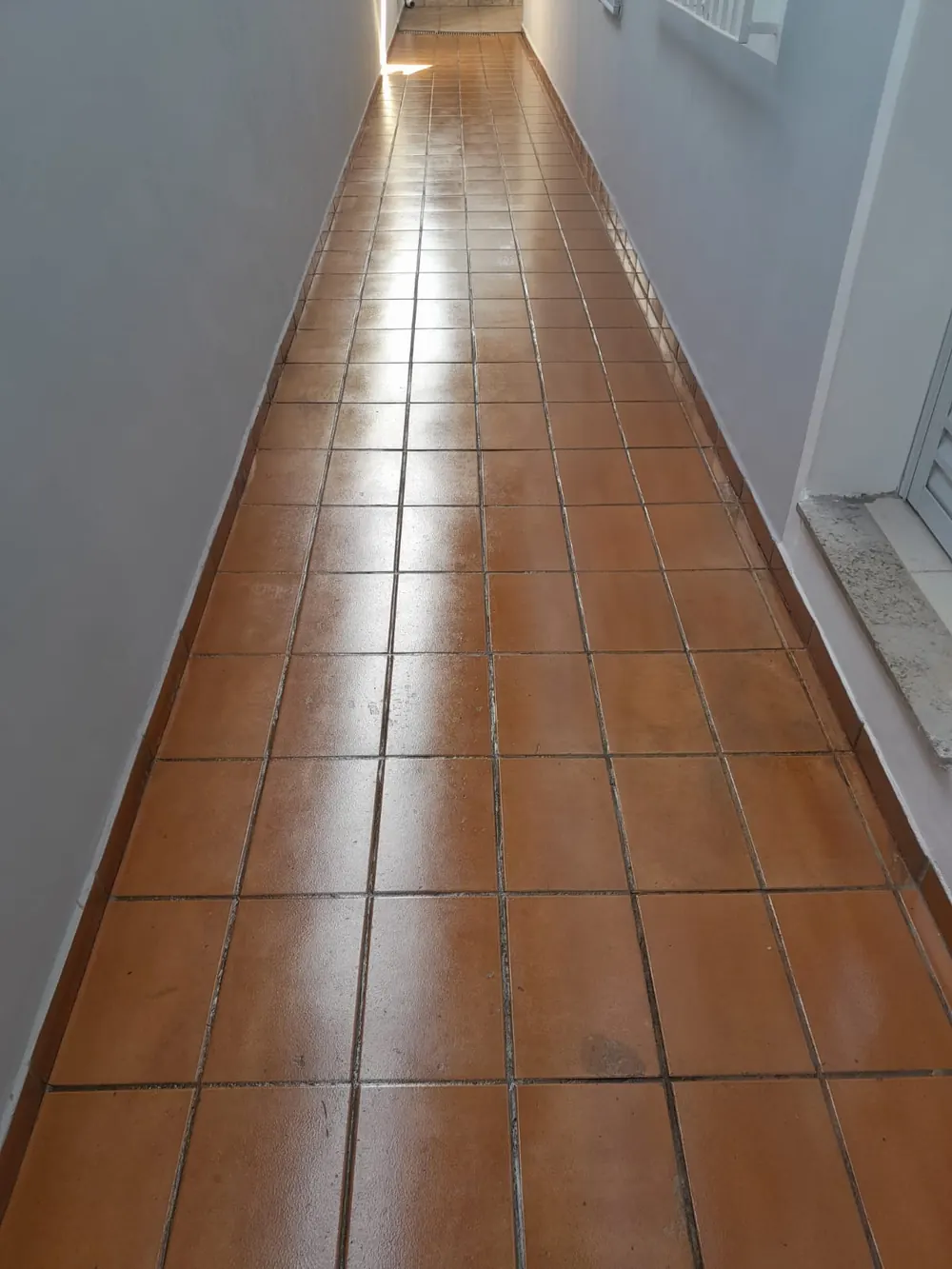 Corredor externo com piso cerâmico depois da revitalização